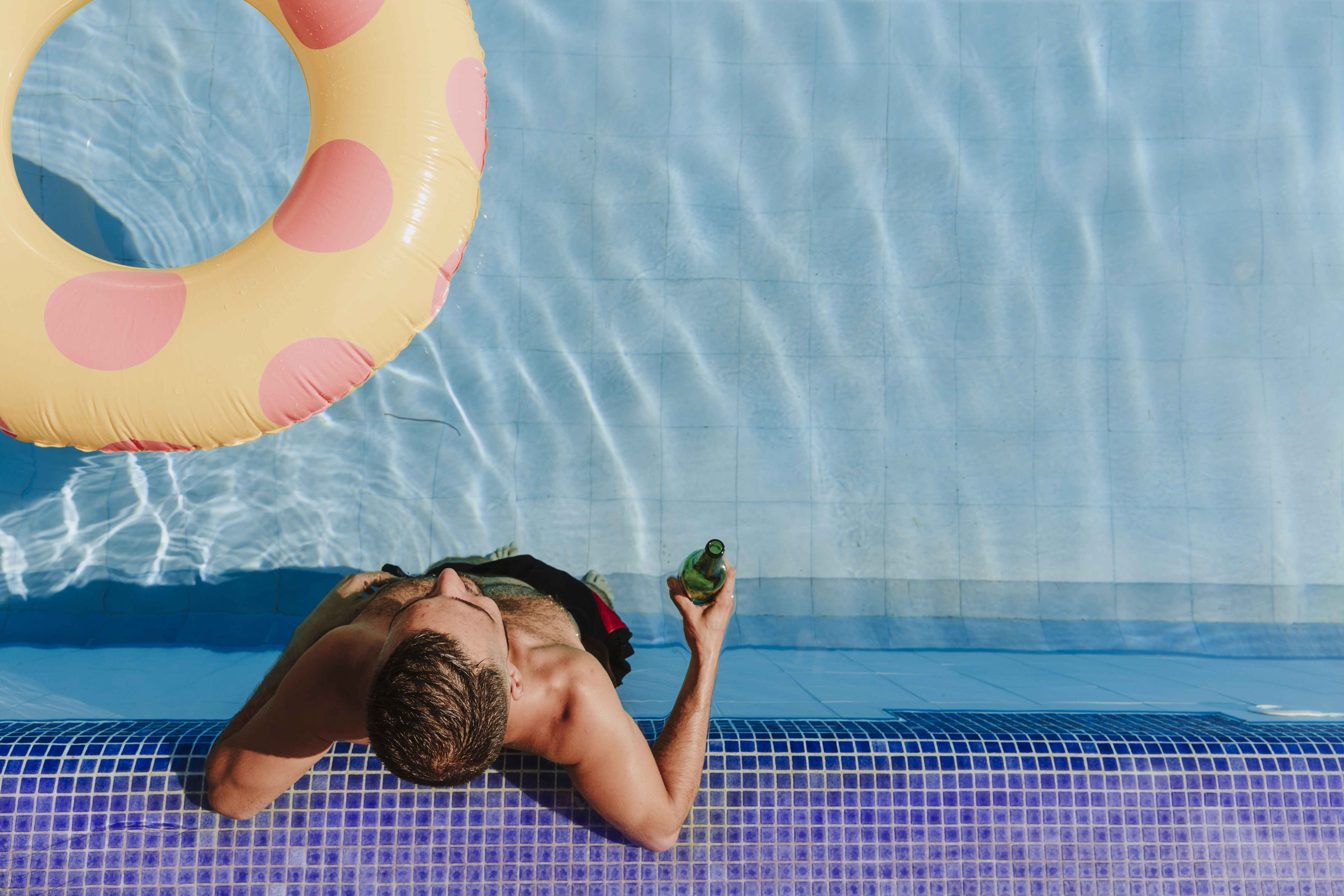 man-relaxing-swimming-pool